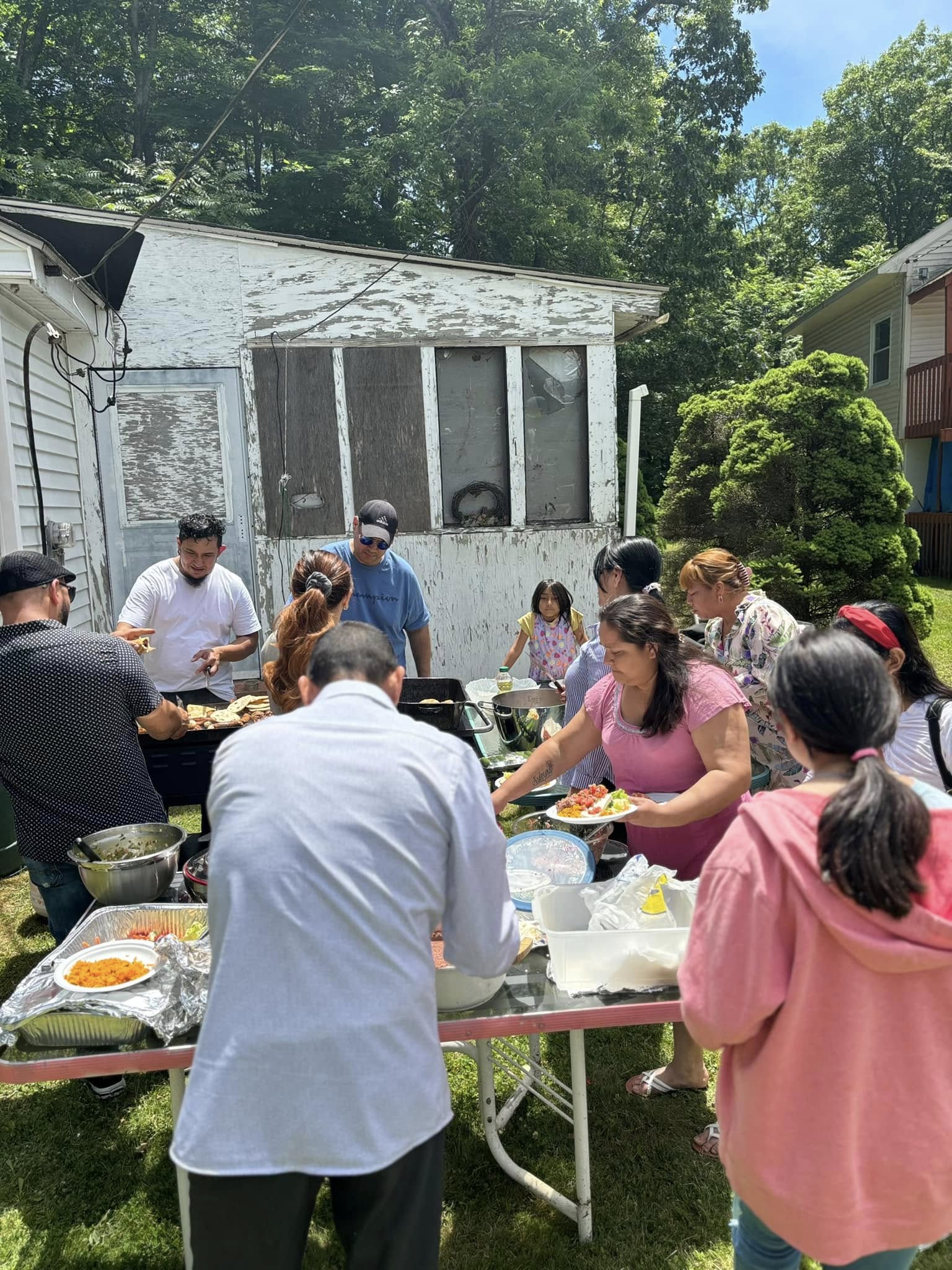 Volunteers and community members gathering to serve—Contact Least Of These Community Center to get involved.